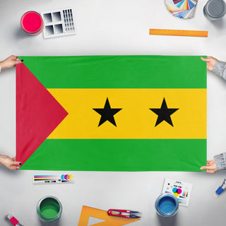 A mockup of the custom flag 'Flag of Sao Tome and Principe' held up on a table during print checking