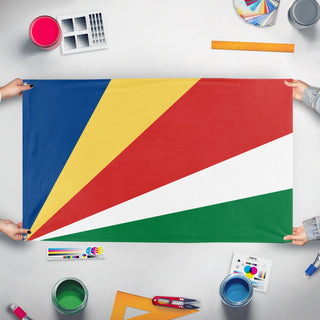 A mockup of the custom flag 'Flag of Seychelles' held up on a table during print checking