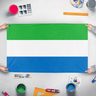 A mockup of the custom flag 'Flag of Sierra Leone' held up on a table during print checking