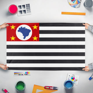 A mockup of the custom flag 'Flag of São Paulo' held up on a table during print checking