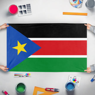 A mockup of the custom flag 'Flag of South Sudan' held up on a table during print checking