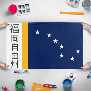 A mockup of the custom flag 'Free State of Fukuoka flag' held up on a table during print checking