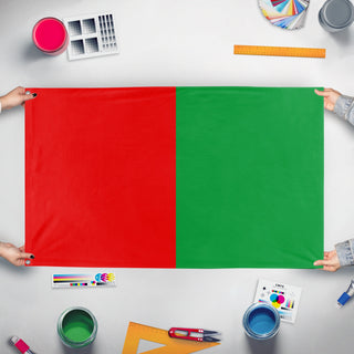 A mockup of the custom flag 'Granada Flag' held up on a table during print checking