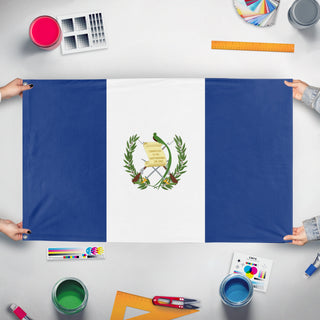 A mockup of the custom flag 'Guatemala flag' held up on a table during print checking