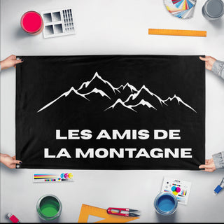 A mockup of the custom flag 'Les Amis De La montagne  flag' held up on a table during print checking