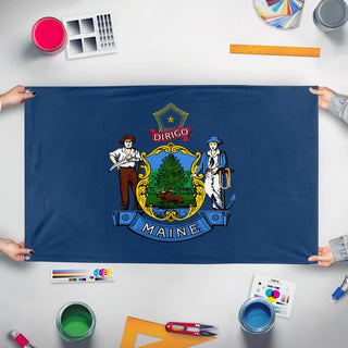 A mockup of the custom flag 'Maine State Flag' held up on a table during print checking