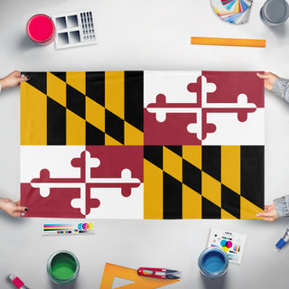 A mockup of the custom flag 'Maryland State Flag' held up on a table during print checking