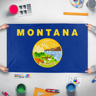 A mockup of the custom flag 'Montana State Flag' held up on a table during print checking