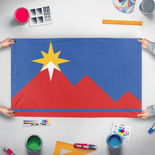 A mockup of the custom flag 'Pocatello, Idaho Flag' held up on a table during print checking