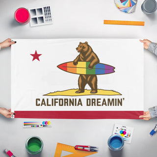 A mockup of the custom flag 'Proud CA Bear flag' held up on a table during print checking