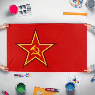 A mockup of the custom flag 'Red Syndicate flag' held up on a table during print checking