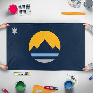 A mockup of the custom flag 'Reno City Flag' held up on a table during print checking
