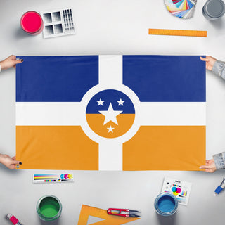A mockup of the custom flag 'Rhelise flag' held up on a table during print checking
