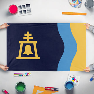 A mockup of the custom flag 'Riverside City Flag' held up on a table during print checking