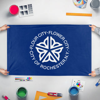 A mockup of the custom flag 'Rochester City Flag' held up on a table during print checking
