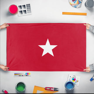 A mockup of the custom flag 'Sibley flag' held up on a table during print checking