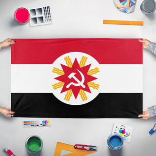 A mockup of the custom flag 'Socialist Iraq Flag' held up on a table during print checking