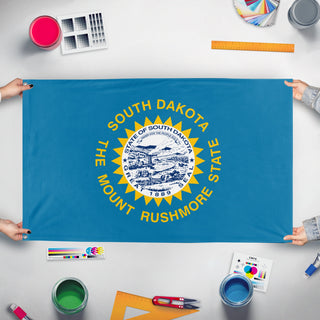 A mockup of the custom flag 'South Dakota State Flag' held up on a table during print checking