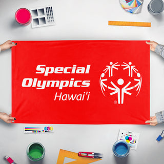 A mockup of the custom flag 'Special Olympics Hawai'i flag' held up on a table during print checking