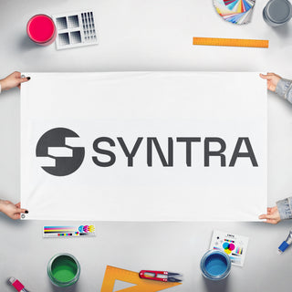 A mockup of the custom flag 'Syntra flag' held up on a table during print checking