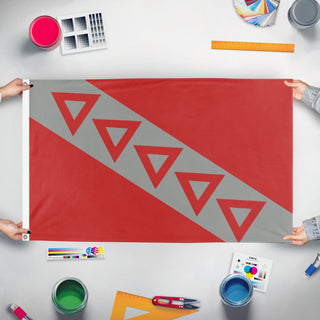 A mockup of the custom flag 'TKE Flag' held up on a table during print checking
