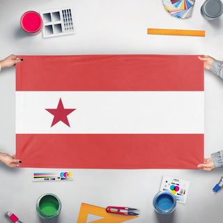 A mockup of the custom flag 'T flag' held up on a table during print checking