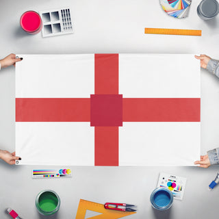 A mockup of the custom flag 'T flag' held up on a table during print checking