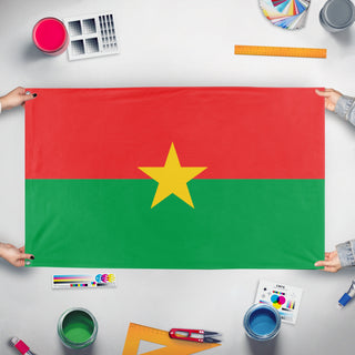 A mockup of the custom flag 'T flag' held up on a table during print checking