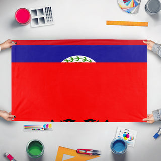A mockup of the custom flag 'T flag' held up on a table during print checking