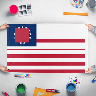 A mockup of the custom flag 'T flag' held up on a table during print checking