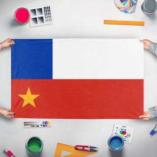 A mockup of the custom flag 'T flag' held up on a table during print checking