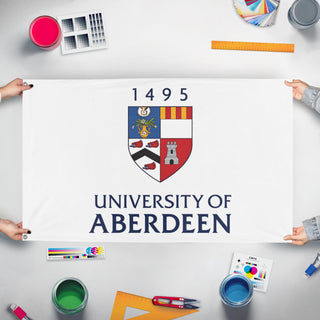 A mockup of the custom flag 'University of Aberdeen flag' held up on a table during print checking
