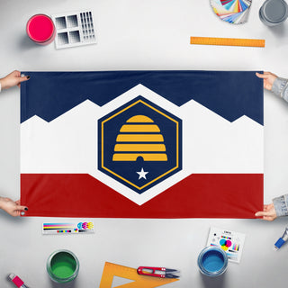A mockup of the custom flag 'Utah State Flag' held up on a table during print checking