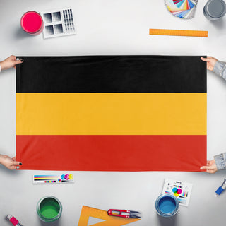 A mockup of the custom flag 'Vocabian flag' held up on a table during print checking
