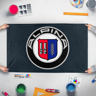 A mockup of the custom flag 'alpina flag' held up on a table during print checking