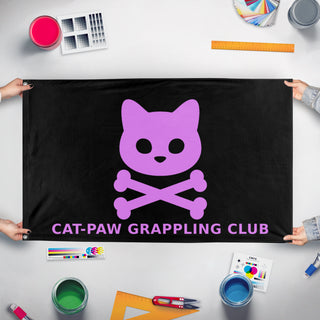 A mockup of the custom flag 'catpaw flag' held up on a table during print checking