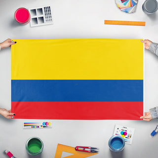 A mockup of the custom flag 'colombia flag' held up on a table during print checking