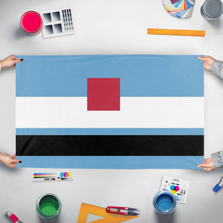 A mockup of the custom flag 'cunt flag' held up on a table during print checking