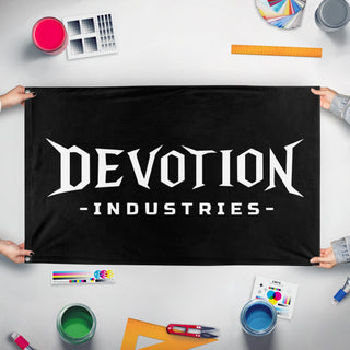 A mockup of the custom flag 'deovtion industries flag' held up on a table during print checking