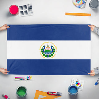 A mockup of the custom flag 'el salvador flag' held up on a table during print checking