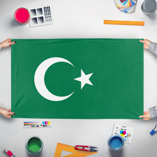 A mockup of the custom flag 'green turkey flag' held up on a table during print checking