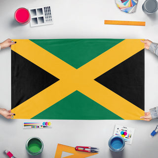 A mockup of the custom flag 'jamaica flag' held up on a table during print checking