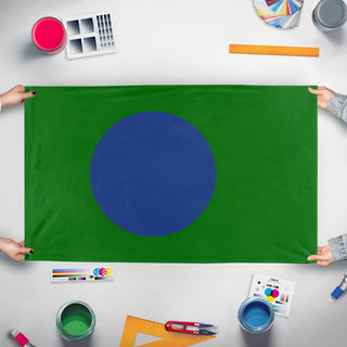 A mockup of the custom flag 'newearth flag' held up on a table during print checking