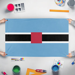 A mockup of the custom flag 'test flag' held up on a table during print checking
