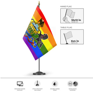 A mockup of the custom flag 'Pennsylvania Pride Flag' as a desk flag and small hand waving flag