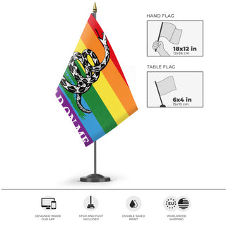 A mockup of the custom flag 'Gadsden Pride Flag' as a desk flag and small hand waving flag