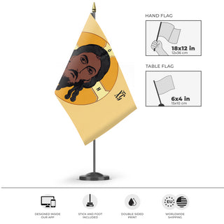 A mockup of the custom flag 'Holy Face of Christ Flag - Yellow flag' as a desk flag and small hand waving flag