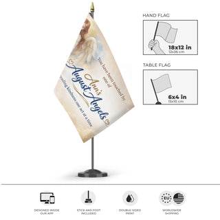 A mockup of the custom flag 'Ann's August Angles flag' as a desk flag and small hand waving flag