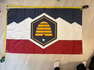 Customer picture of our custom Utah State Flag, manufactured with 4 grommets. 